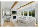 Bright living room featuring a fireplace, built-in shelving, and large windows at 2 Piedmont Ave # A, Charleston, SC 29403