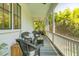 Cozy screened porch with wicker seating, area rug, and a view of lush greenery at 2 Piedmont Ave # A, Charleston, SC 29403