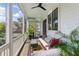 Inviting screened porch with comfortable seating, ceiling fan, and views of the surrounding landscape at 2 Piedmont Ave # A, Charleston, SC 29403
