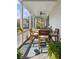 Relaxing screened porch with a wooden table and chairs, perfect for outdoor dining at 2 Piedmont Ave # A, Charleston, SC 29403