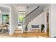 Staircase with hardwood steps and black metal railings. A bench and indoor plant decorate the space at 2 Piedmont Ave # A, Charleston, SC 29403