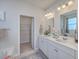 Bright bathroom with double sink vanity, modern fixtures, and a separate doorway to the walk-in closet at 215 Shortmarsh St, Summerville, SC 29486