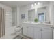 Well-lit bathroom with double sinks, a bathtub-shower combo, and neutral-toned walls creating a clean, fresh ambiance at 215 Shortmarsh St, Summerville, SC 29486