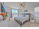 Comfortable bedroom with a ceiling fan, large window, and a well-appointed dresser at 215 Shortmarsh St, Summerville, SC 29486