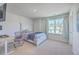 Bright bedroom with a large window overlooking the neighborhood, featuring a desk and a comfortable bed at 215 Shortmarsh St, Summerville, SC 29486