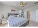 Comfortable bedroom with a ceiling fan and large window with a nightstand and full-length mirror at 215 Shortmarsh St, Summerville, SC 29486