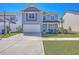 Charming two-story home with a manicured lawn, inviting front porch, and a spacious driveway at 215 Shortmarsh St, Summerville, SC 29486