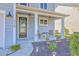 Charming front porch with seating, decorative flower pots, and a well-manicured landscape at 215 Shortmarsh St, Summerville, SC 29486