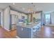 Modern kitchen with white cabinetry, granite countertops, a center island, and stainless steel appliances at 215 Shortmarsh St, Summerville, SC 29486