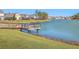 Scenic lake view showcasing a wooden pier and the surrounding neighborhood houses at 215 Shortmarsh St, Summerville, SC 29486