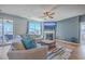 Comfortable living room featuring a sectional sofa, fireplace, TV, and access to an outdoor patio at 215 Shortmarsh St, Summerville, SC 29486