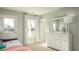 Bright bedroom features a white dresser, a large mirror, and two windows letting in plenty of natural light at 216 Yalton St, Summerville, SC 29486