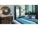 Nicely decorated bedroom with colorful striped walls, matching striped bedding, and decorative wall art at 216 Yalton St, Summerville, SC 29486