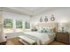 Serene bedroom with a tufted headboard, plush bedding, and views of the lush outdoors at 216 Yalton St, Summerville, SC 29486