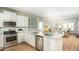 Bright kitchen with stainless steel appliances, granite countertops, and wood floors open to the living room at 216 Yalton St, Summerville, SC 29486
