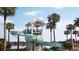 Community water slide structure surrounded by palm trees, landscaping, and a nearby lake at 216 Yalton St, Summerville, SC 29486