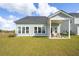 Large backyard features a covered patio and well-maintained lawn, perfect for outdoor gatherings at 220 Callibluff Dr, Summerville, SC 29486