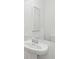 Simple bathroom featuring a pedestal sink, mirror, and a white color scheme at 220 Callibluff Dr, Summerville, SC 29486