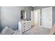 Neutral bedroom with white dresser, decor, and open doorway at 220 Callibluff Dr, Summerville, SC 29486