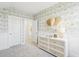 Stylish bedroom featuring wallpaper, a dresser with decor, and carpeted floors at 220 Callibluff Dr, Summerville, SC 29486