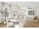 Bright dining room features hardwood floors, a beaded chandelier, and backyard views at 220 Callibluff Dr, Summerville, SC 29486