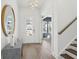 Inviting entryway with a stairs to the right and stylish table under a round mirror at 220 Callibluff Dr, Summerville, SC 29486