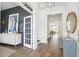 Welcoming entryway with a stylish table, round mirror, and view into the adjacent home office at 220 Callibluff Dr, Summerville, SC 29486
