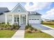 Charming exterior with a two-car garage, covered porch and manicured lawn at 220 Callibluff Dr, Summerville, SC 29486