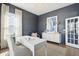 Stylish home office with dark gray walls, white trim, a large window, and modern furniture at 220 Callibluff Dr, Summerville, SC 29486