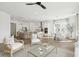 Bright, open-concept living space with modern decor, hardwood floors, and a view into the kitchen at 220 Callibluff Dr, Summerville, SC 29486