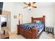 Bedroom with a rustic wooden bed frame and a ceiling fan at 224 Jackson St, Goose Creek, SC 29445
