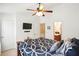 Bedroom with a rustic wooden bed frame, ceiling fan and a mounted TV at 224 Jackson St, Goose Creek, SC 29445
