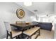 Dining area with modern table, decorative clock, and an open flow to the living room at 224 Jackson St, Goose Creek, SC 29445