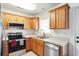 Well-lit kitchen featuring stainless steel appliances, wood cabinets, and neutral countertops at 224 Jackson St, Goose Creek, SC 29445