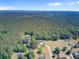 Vast aerial view of a home nestled amid lush greenery with surrounding neighborhood at 225 Ridge Rd, Ridgeville, SC 29472