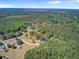 Expansive aerial view of a home nestled in a neighborhood surrounded by dense forest and a blue sky at 225 Ridge Rd, Ridgeville, SC 29472