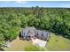 Aerial view of a property showcasing a wooded area, three-car garage, and outdoor playground at 225 Ridge Rd, Ridgeville, SC 29472