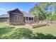 Spacious backyard with a stone patio, outdoor seating, and a well-manicured lawn at 225 Ridge Rd, Ridgeville, SC 29472