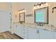 Bathroom featuring dual sinks, framed mirrors, granite countertops, and modern lighting at 225 Ridge Rd, Ridgeville, SC 29472
