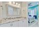 Bathroom with double sink vanity, granite countertops, white cabinets, and access to the bedroom at 225 Ridge Rd, Ridgeville, SC 29472