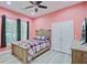 Bedroom with pink walls, wood-look floors, and a comfortable queen bed at 225 Ridge Rd, Ridgeville, SC 29472