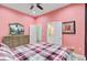 Bedroom featuring pink walls, wood-look floors, and a view to the bathroom at 225 Ridge Rd, Ridgeville, SC 29472