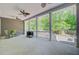 Spacious covered patio with multiple ceiling fans, rocking chairs, and a grill at 225 Ridge Rd, Ridgeville, SC 29472