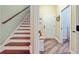 Inviting entryway showcasing hardwood stairs and flooring with a white front door at 225 Ridge Rd, Ridgeville, SC 29472