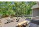 Charming outdoor fire pit area with ample seating and a wooded backdrop at 225 Ridge Rd, Ridgeville, SC 29472