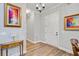 Elegant hallway featuring hardwood floors, neutral walls, and decorative artwork enhancing the ambiance at 225 Ridge Rd, Ridgeville, SC 29472