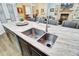 Close-up of the kitchen island featuring a double sink and granite countertop at 225 Ridge Rd, Ridgeville, SC 29472