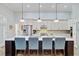 Bright kitchen with white cabinets, stainless steel appliances, and a large center island with seating at 225 Ridge Rd, Ridgeville, SC 29472