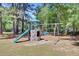 Community playground featuring a slide, climbing structure, and swings, set among mature trees at 225 Ridge Rd, Ridgeville, SC 29472