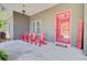 Inviting front porch with vibrant red seating and a charming welcome sign near the front door at 225 Ridge Rd, Ridgeville, SC 29472